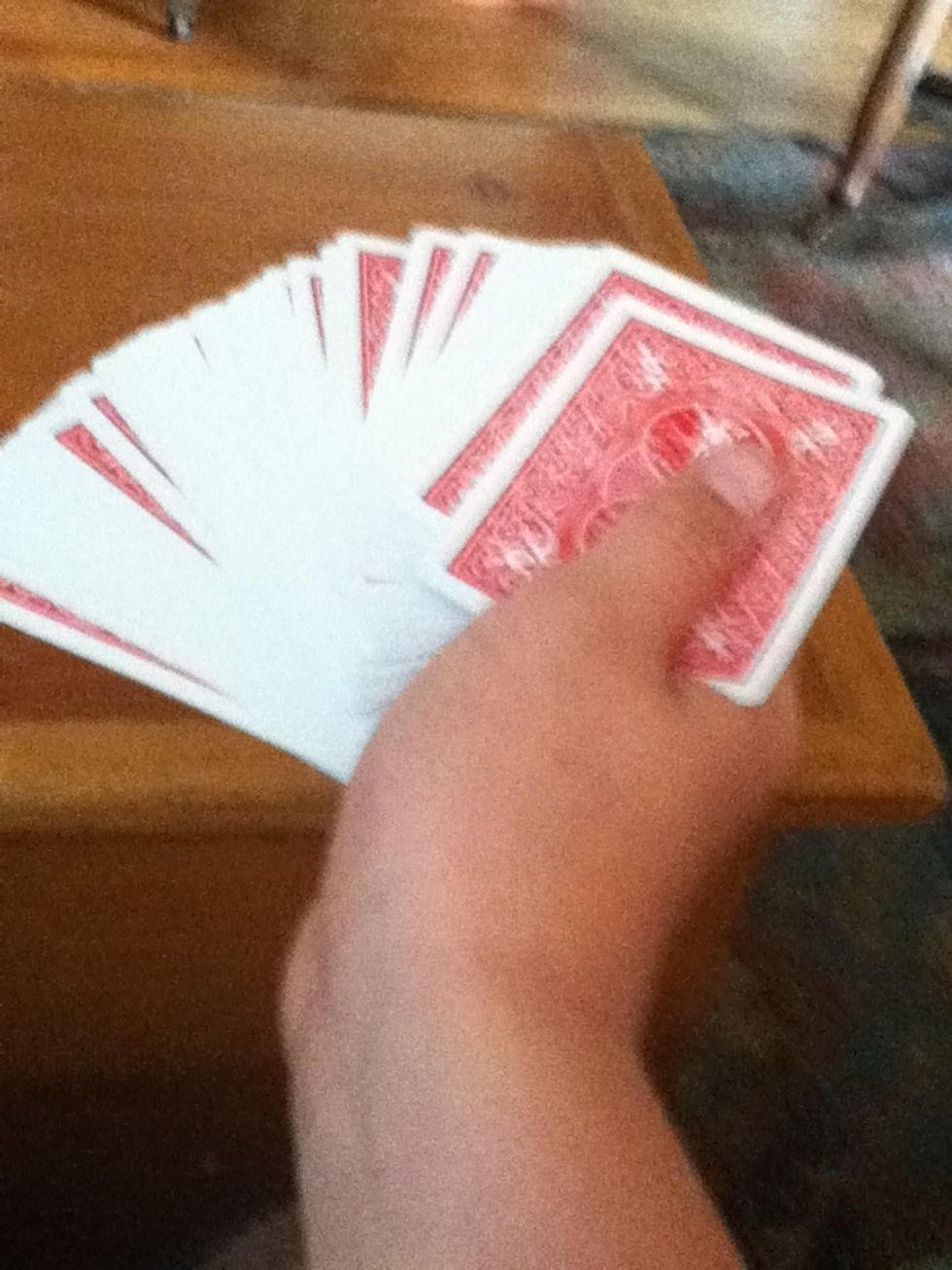 tell them to pick a card. don't let them see the bottom card.