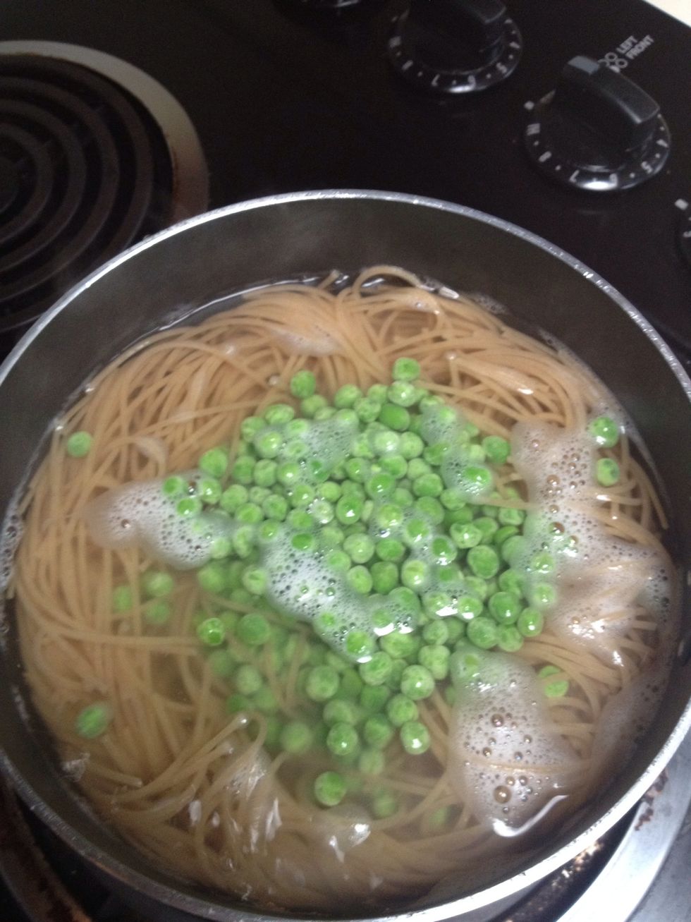 Test a strand of pasta, if it feels like it needs more time add the frozen peas. Drain when done