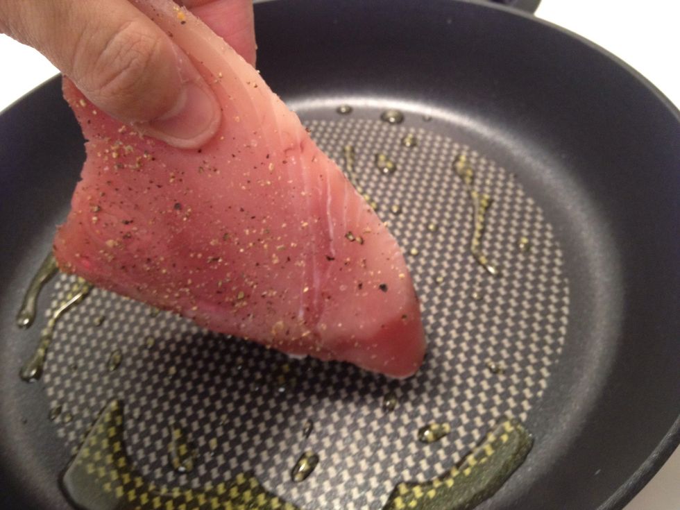 Test the pan by lightly pressing the fish against the surface. If it sizzles, you're good to go.