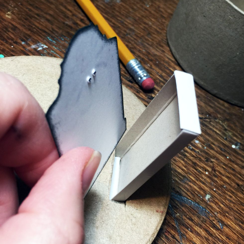 Test to see if the eye holes on the grave stone image will be inside the matchbox and that you will still have some of the matchbox to stick in the hole.
