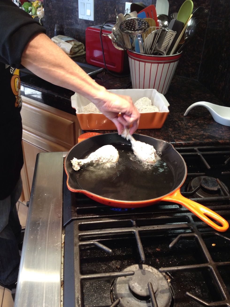 Test to see that the pan is hot, then add the drumlettes one by one. Make sure you leave plenty of space in the pan; you don't want to crowd the chicken as you fry it.