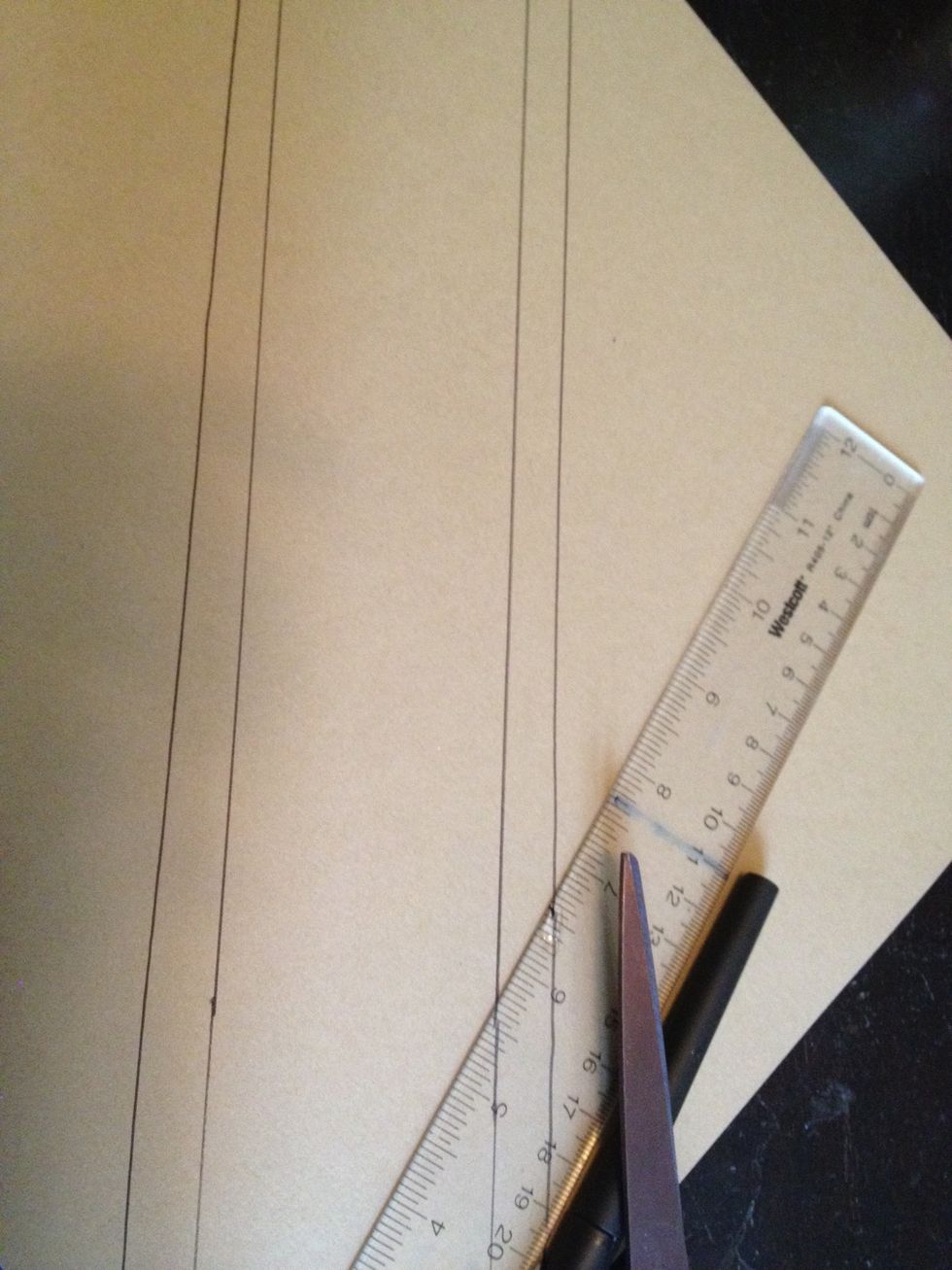 than trace and cut a smaller version of the rectangle (about a 1/2 inch smaller) on the lighter sheet of brown paper.