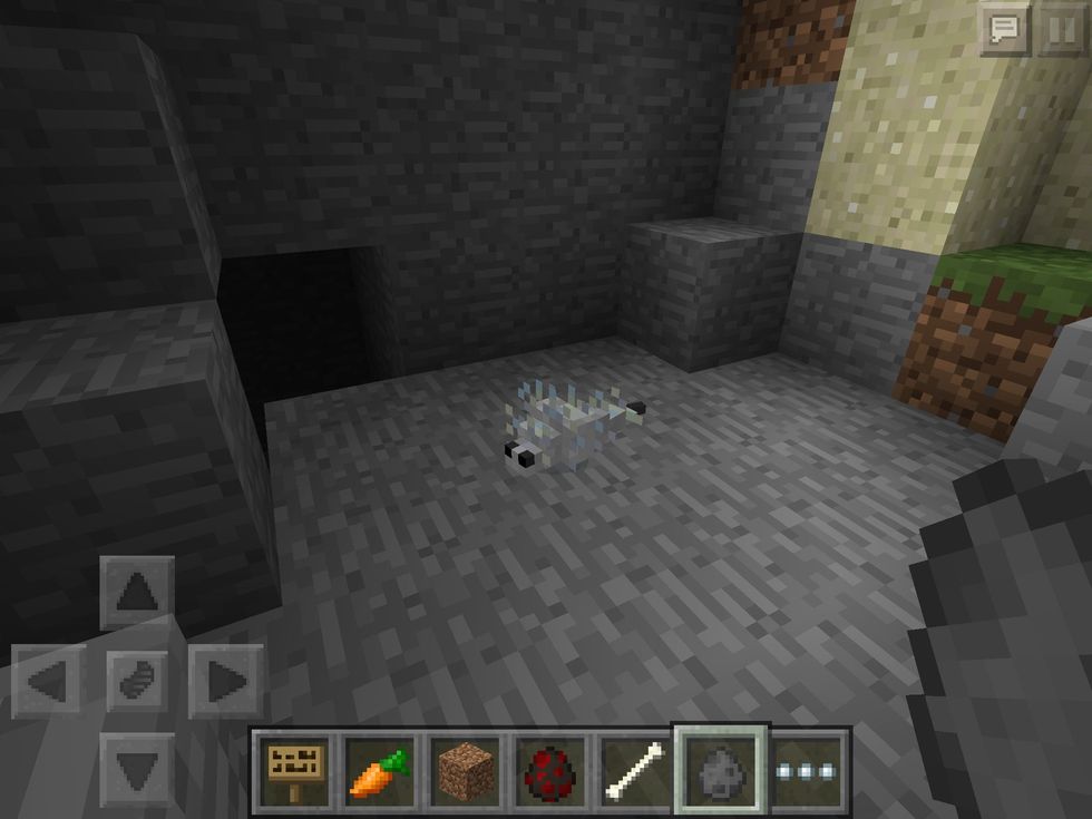That's a Silverfish! They are small, skittish mobs that you may never ever see, which is a good thing! They hide in blocks, so watch out if you find a stronghold, they like those areas!