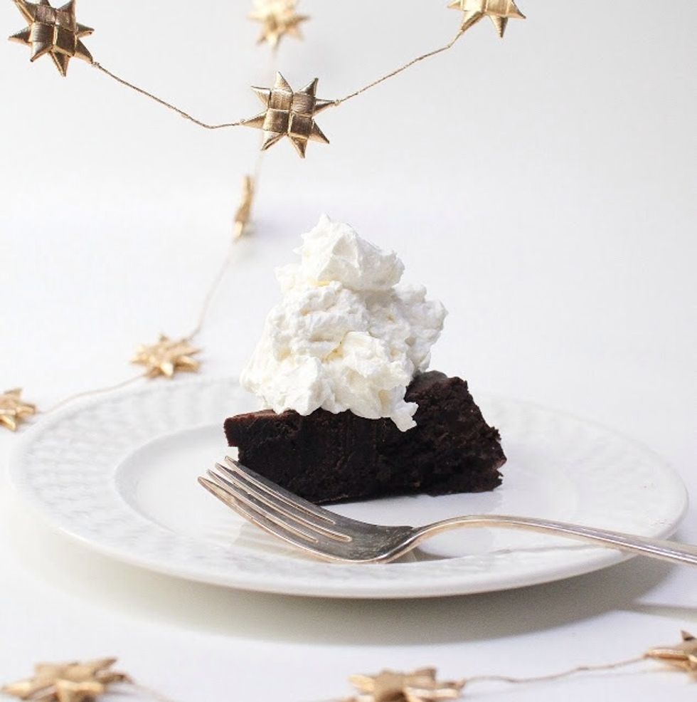 That's it! Serve it up with a bit of unsweetened whipped cream. We're in teeny tiny serving territory here. A skinny little slice is what is called for as it's a very rich cake.