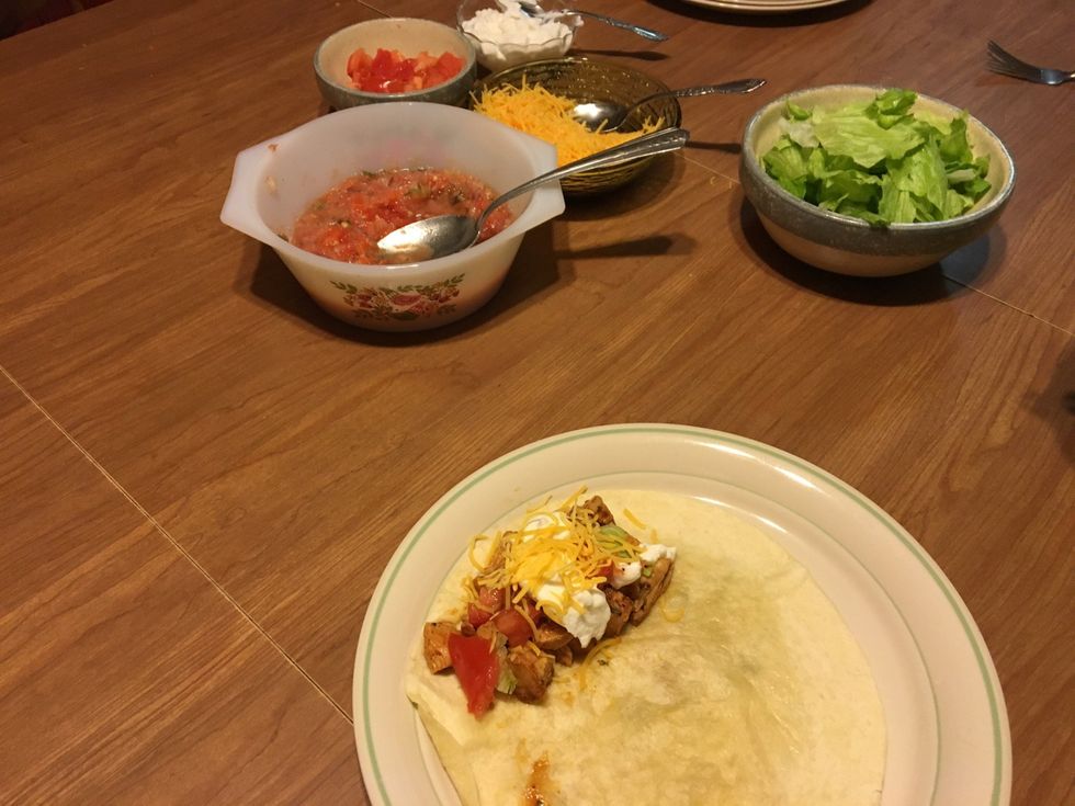Thaw chicken breast. Cook chicken breast throughly. Cut chicken into small pieces. Prepare with fajita seasoning as directed on package. Brown shells on stove. Add chicken and all toppings to tacos
