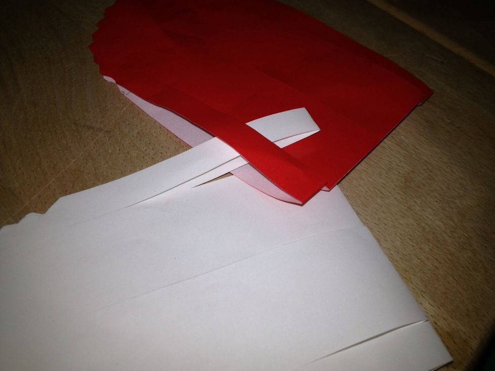 The 1.white strip goes thru the 1.red strip next the 2.red strip goes thru the 1. white strip,then the 1. white strip goes thru the 3. red strip finally the 4. red strip goes thru the 1. white strip.