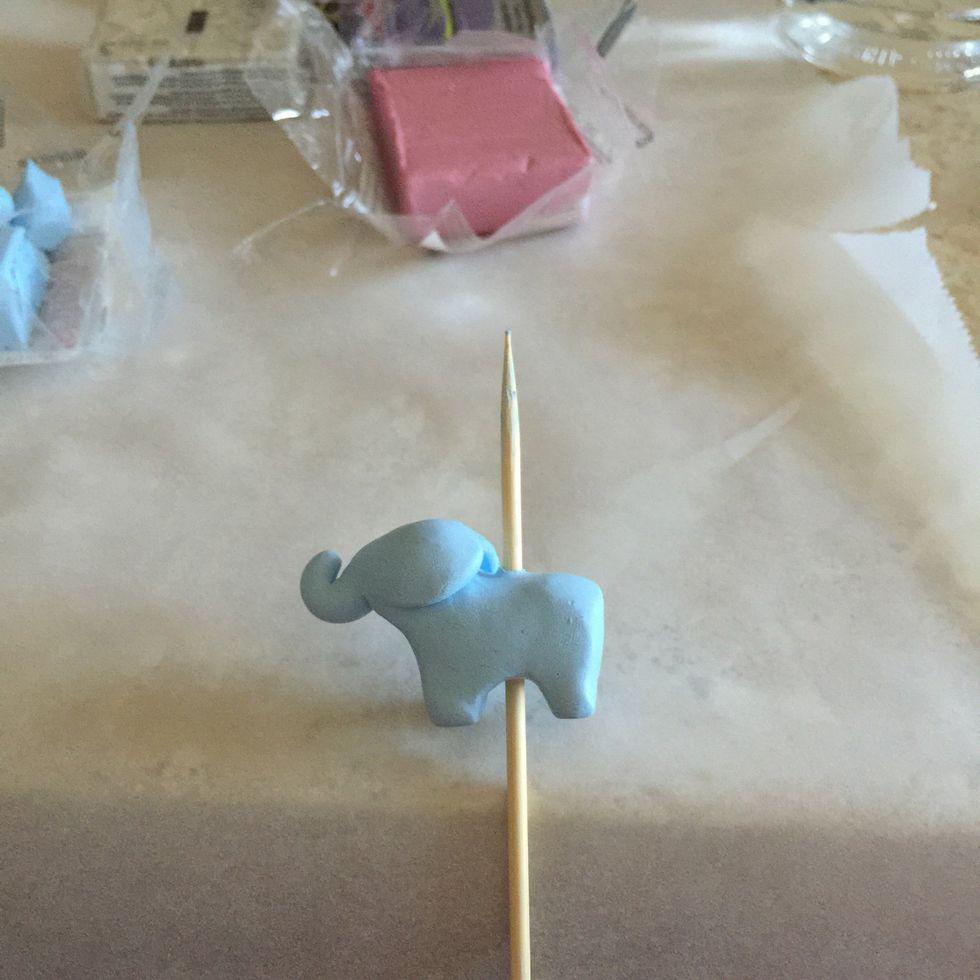 The awfully terrifying part: sticking a skewer or similar object through your totem to create the hole in which string will go through. Make sure to create a hole large enough for the tassel string.