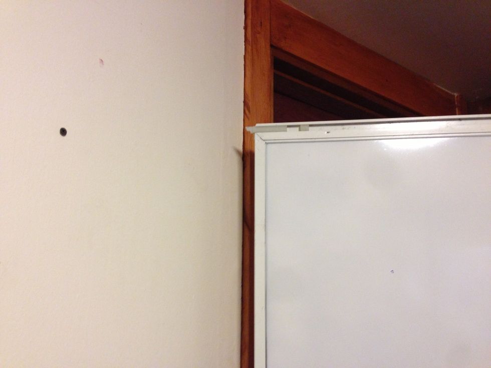 The backside of the window showing the window track to mount it on the wall. Hang from a screw sticking 1/8" out of wall.