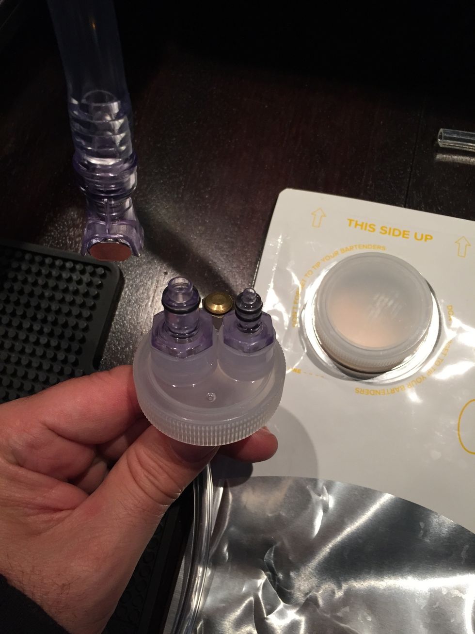 The beer cap has connectors for the CO2 and beer lines. Practice connecting and disconnecting them before you add a full bag. Bag should be inserted with cap facing up and to the right.