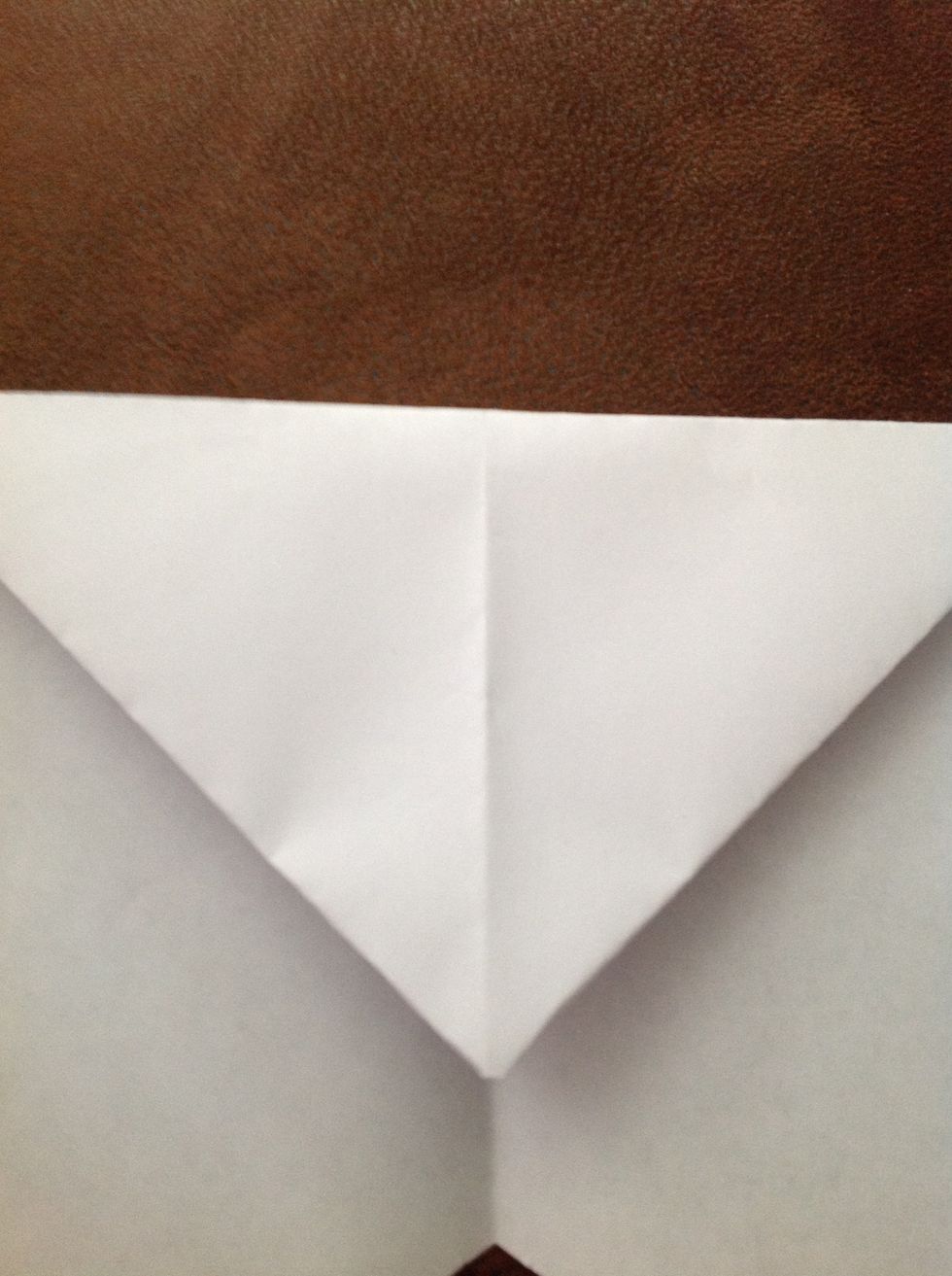 The bottom edge of the corners that you just folded down should create a straight line across the page. Fold down at this line.