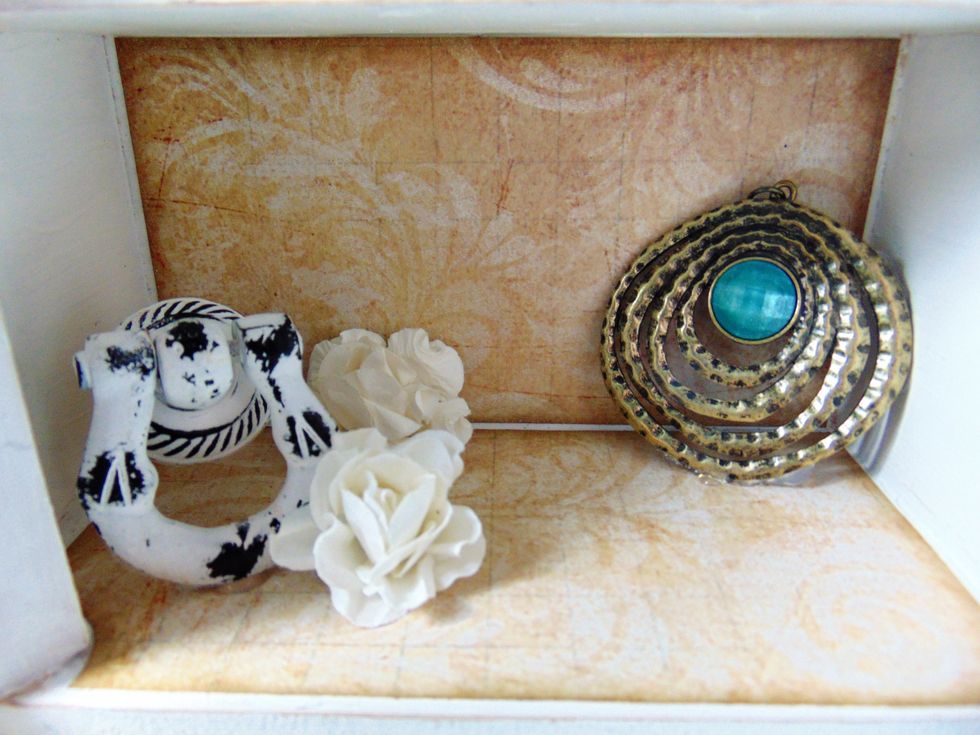 The bottom shelf I added some of the larger items from the kit with some flowers.