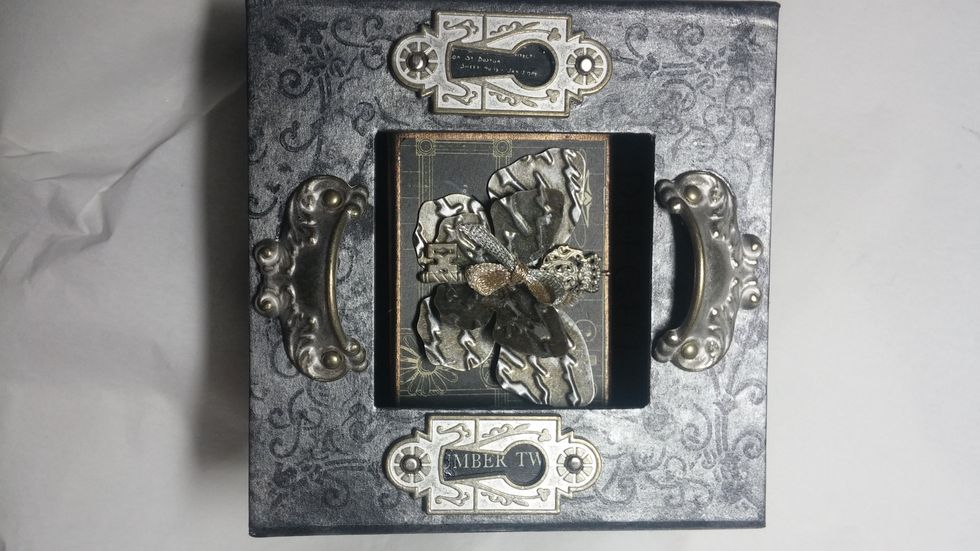 The box was mounted on top of an old wooden spool to give it height and depth.