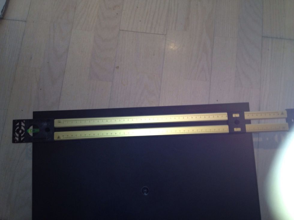 The cabinet have small holes on the back for hanging. Mark the distance between them on your spirit level.