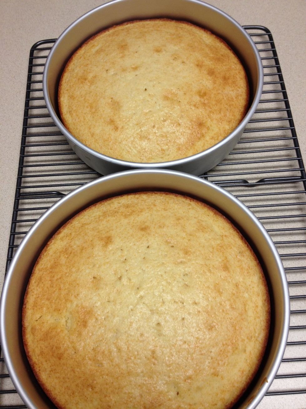 The cake is done, let cool in the pans for about ten minutes.  Then use a butter knife to loosen the sides and turn out into cooling rack.