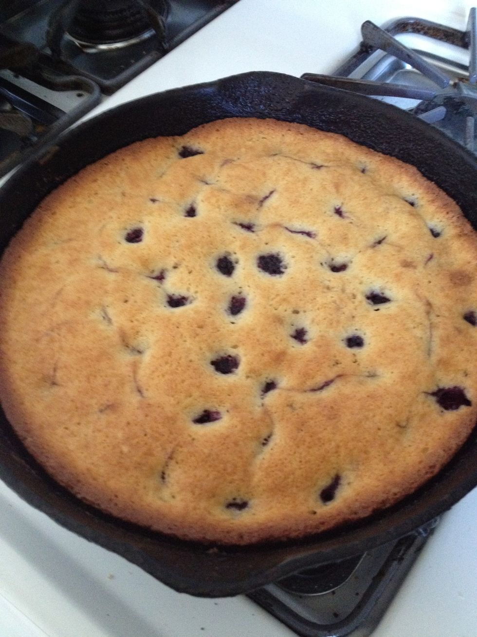 The cake is done! Remove from the oven and let cool slightly. It smells sooooo good! And check out the backberries peeking up through the cake. \ud83d\udc40