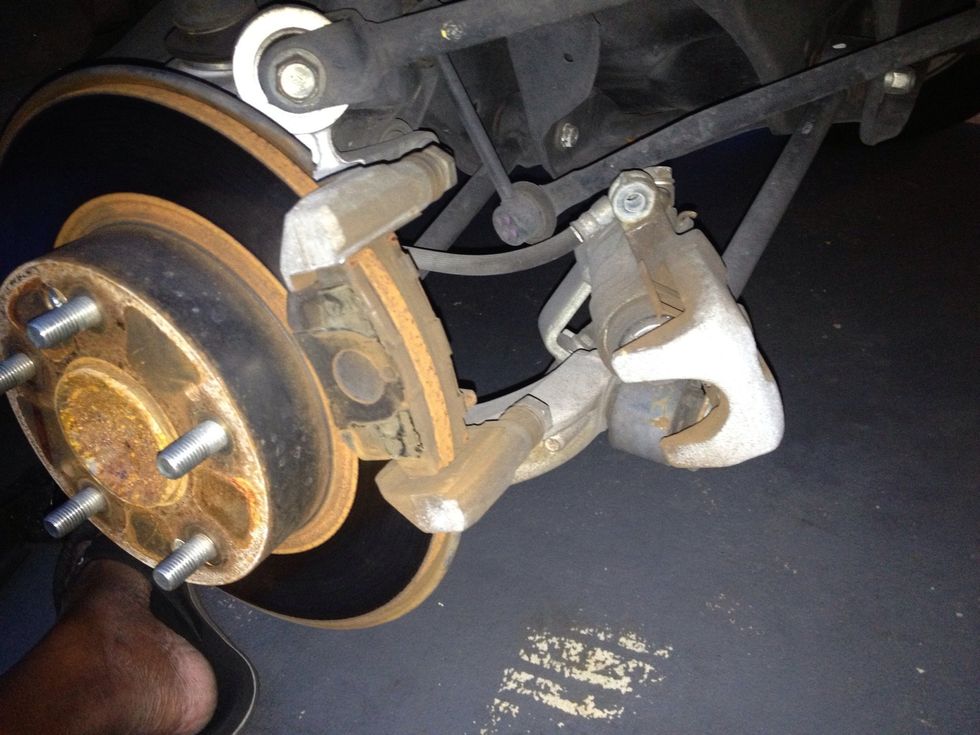 The caliper will slide off, then remove the old brake pads