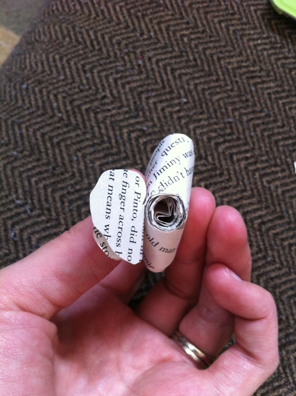 The center of the spiral becomes the bottom of the rose. I then hot glue that flap to the bottom of the rose.