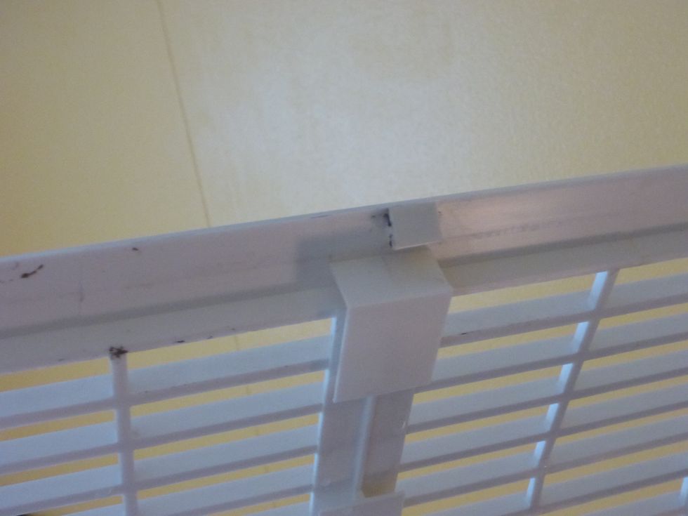 The chassis is held in place by plastic tabs. The top tabs look like this when the chassis is removed.