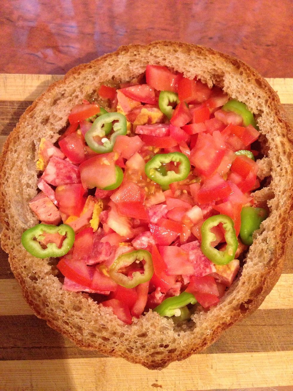 The chop tomatoes and peppers and add into the bread