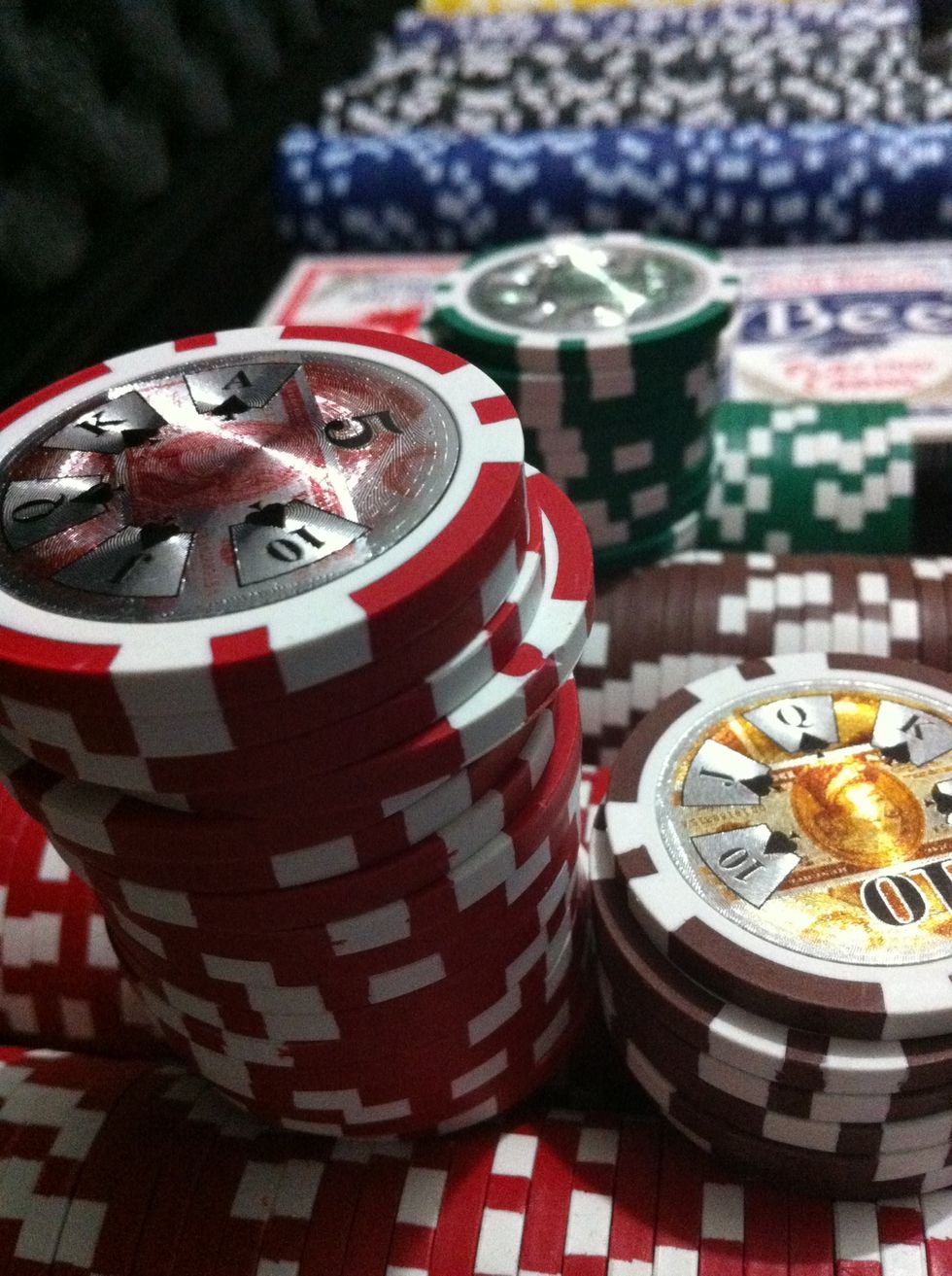 The common currency used on poker games is "Chips". It is used to represent money. You may use anything you like. You will bet using this, placing your bet in the middle of the table: the "pot".