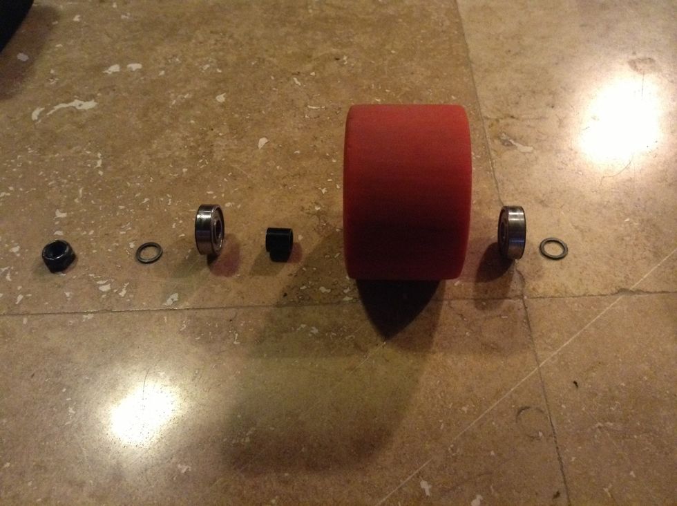 The components are assembled in the following order along each of the four axle sections on the trucks with the axle facing outwards. The bearings and bearing spacer will remain inside the wheel.