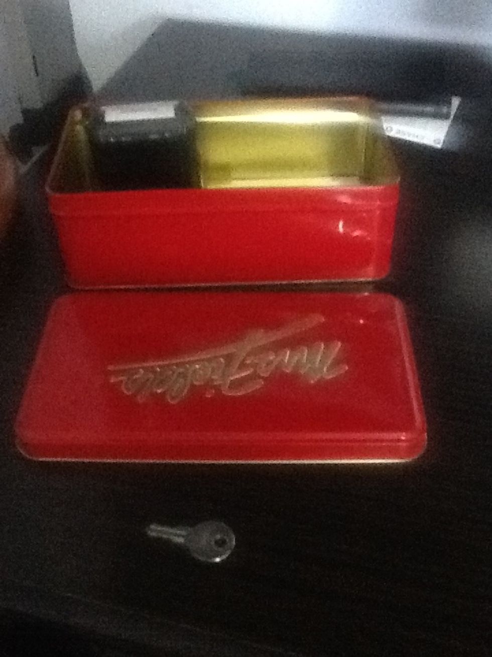 the cookie tin is usually stored near Chris' desk.