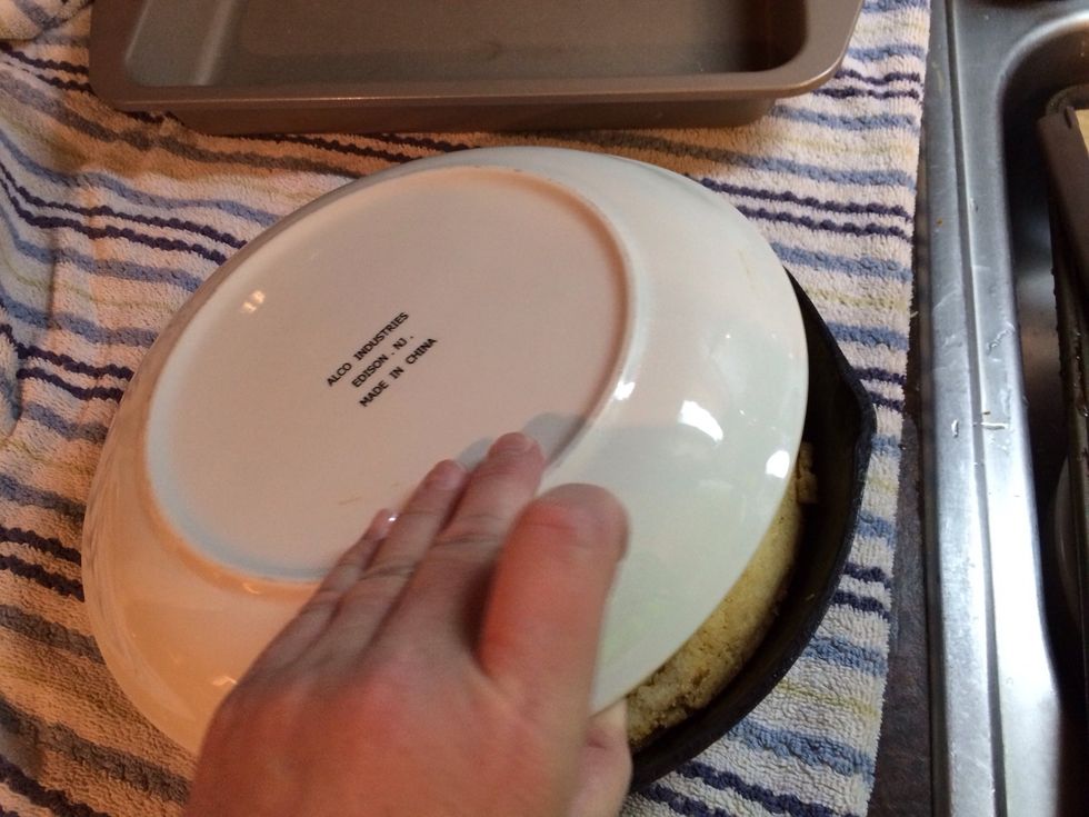 The cornbread is cool. Place a plate over.