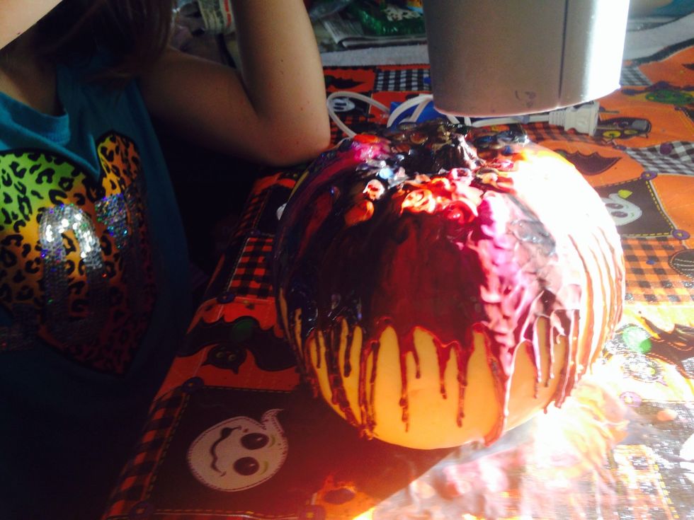 The crayons melt to cover the pumpkin