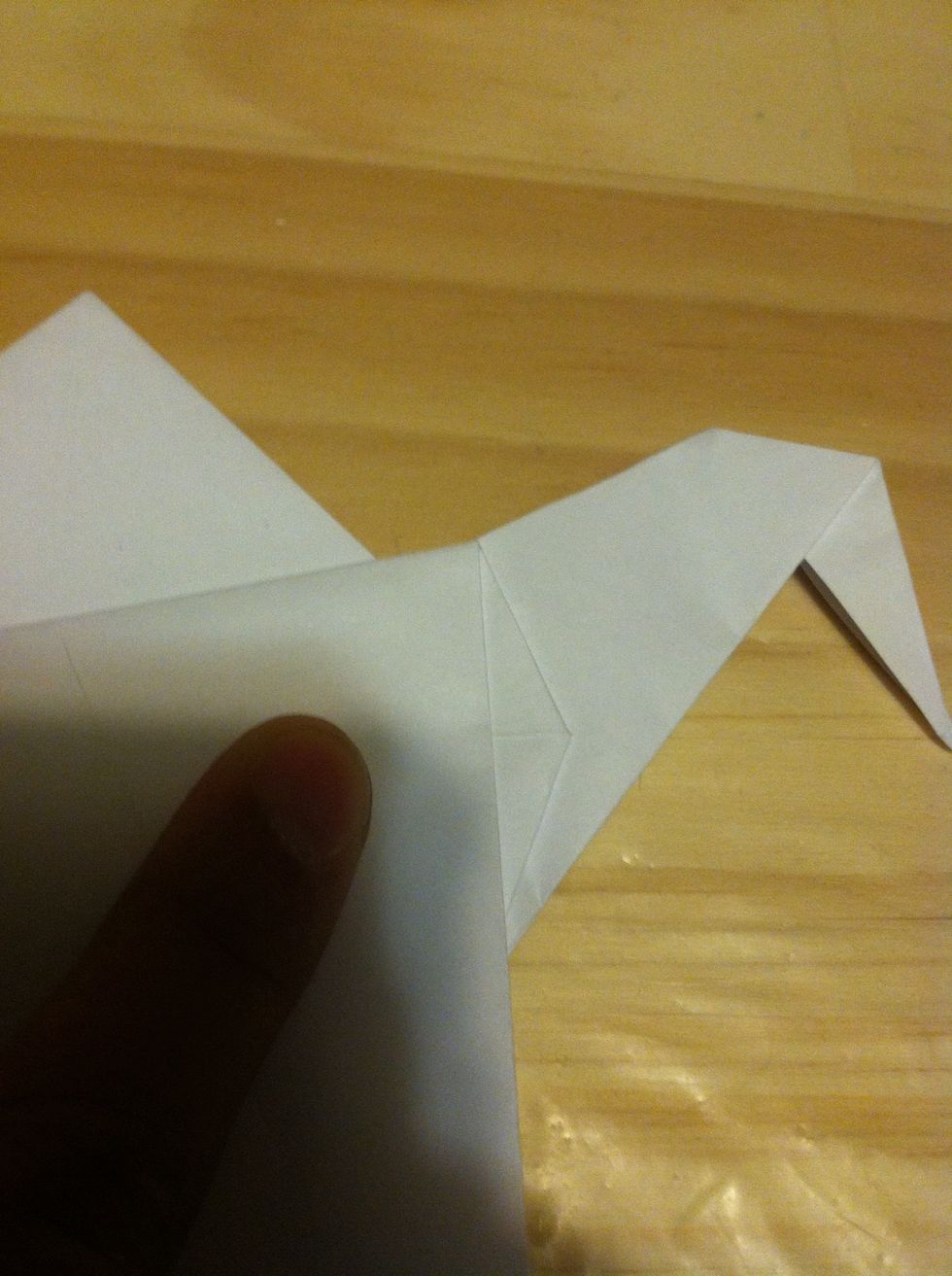 The crease should end up along the crane's neck.