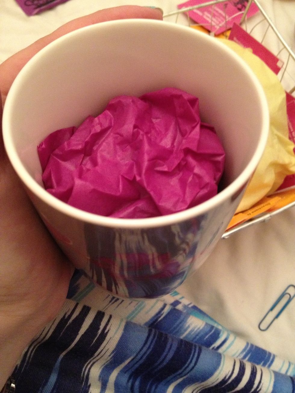 The cups I have are tall so gently gather some tissue paper and place inside
