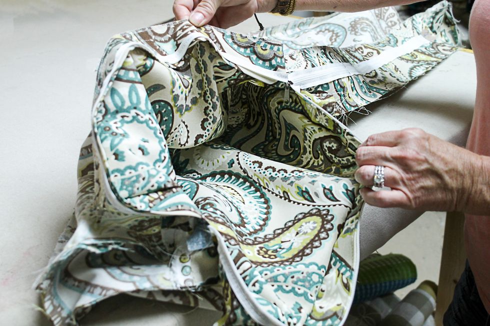 The cushion will still be inside out at this point.  Work the zipper tab to the up position and slide the zipper open.  Turn.
