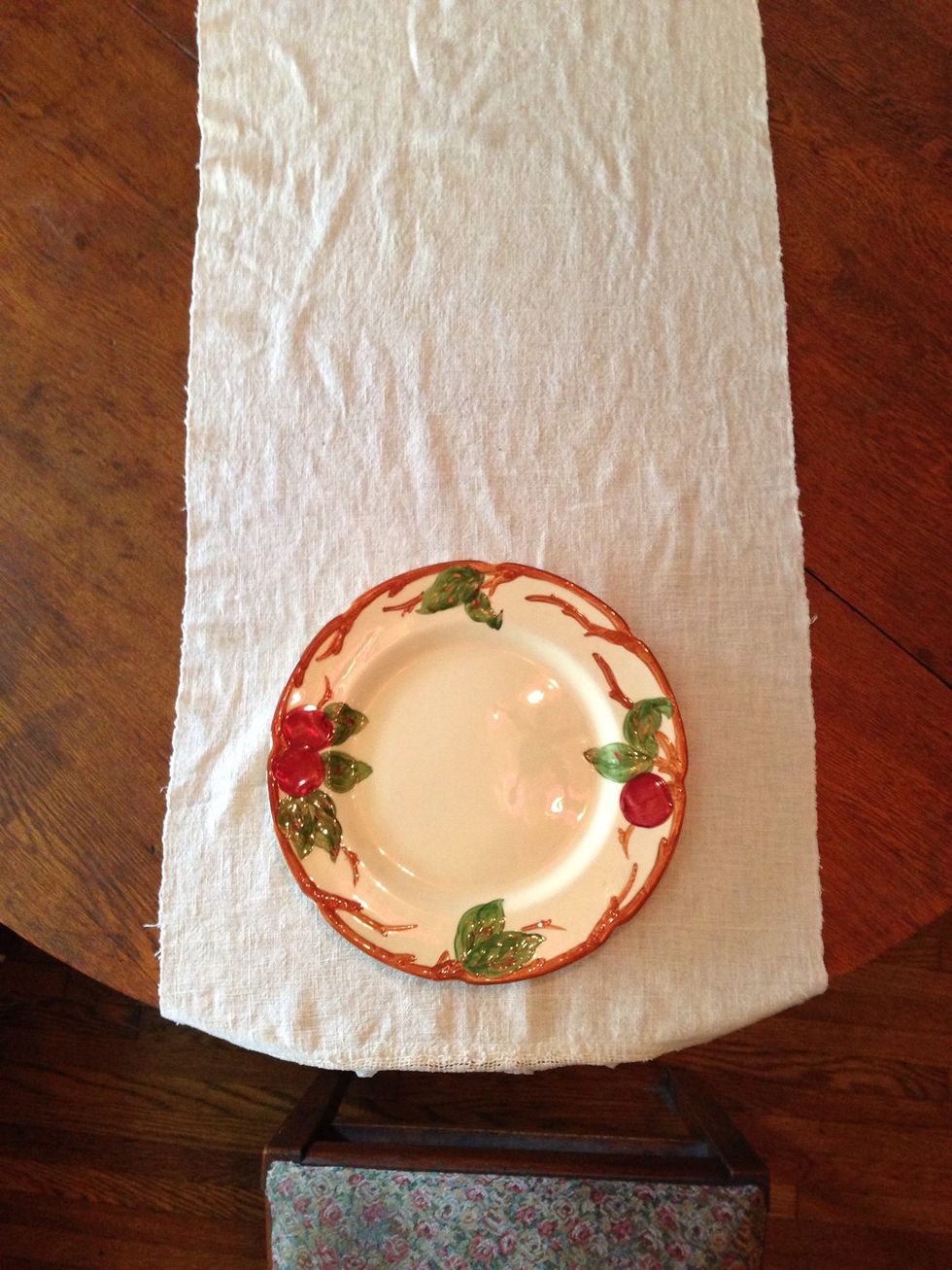 The dinner plate should be 2 to 3 inches from the edge of the table in front of each chair.