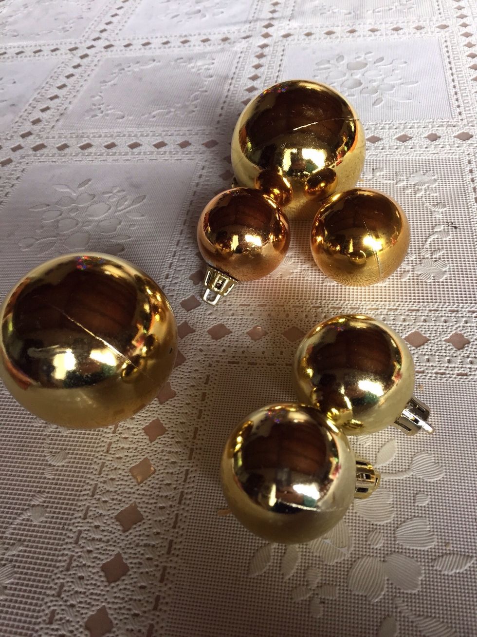The Dollar Store is a great place to purchase ornaments. Make sure you get smaller sized ones that look proportioned to the larger 'head' ornament.