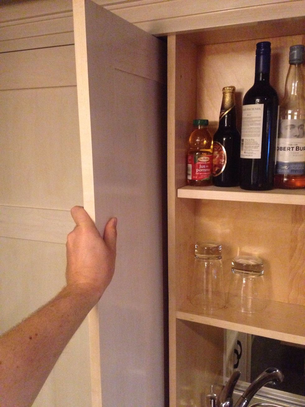 The doors open and partially retract into the cabinet