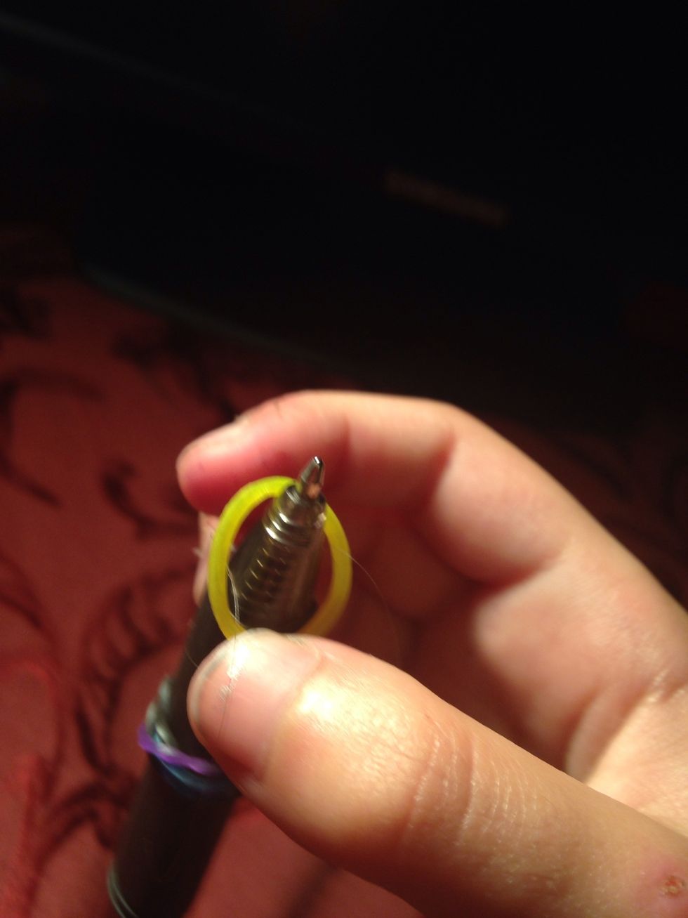 The easier way is put half of the band in the pen then turn it into An eight