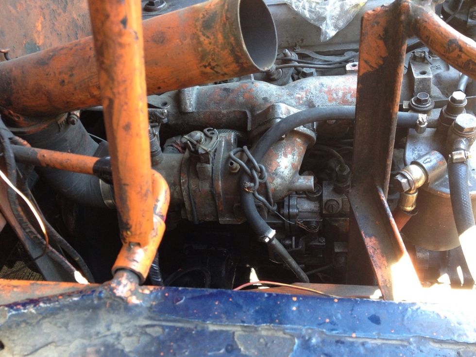 The engine / motor number of a 4BA1 Isuzu engine is located at the right side. Remove the air cleaner to allow more access.