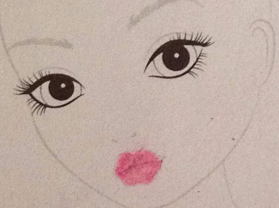 The face: colour in the lips in dark pink.