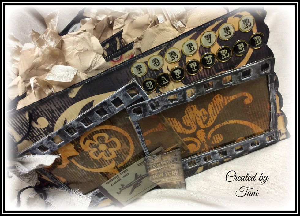 The filmstrips were cut from cardboard and then painted black, rubbed off a bit. Acetate was colored with Ginger Alcohol Ink and adhered to the back of the filmstrip dies.