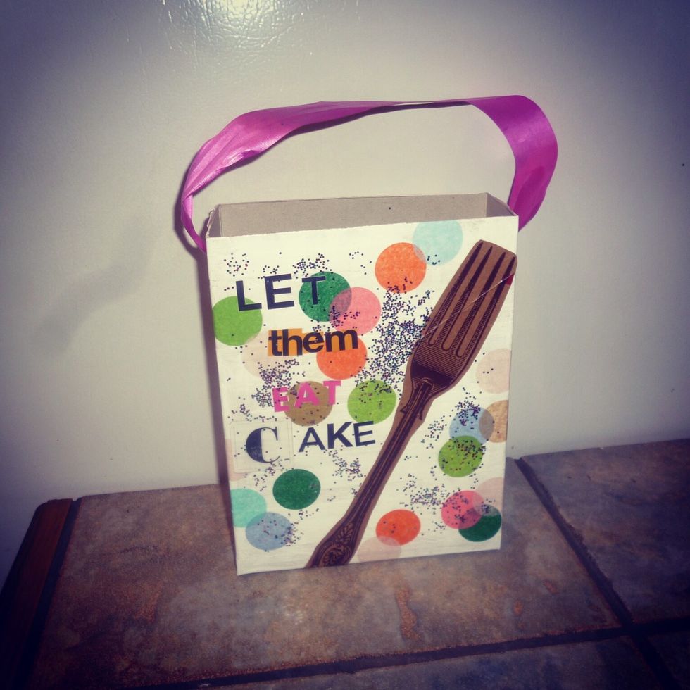 The final step is using the hole punch to add a hole to each of the sides of your gift bag. This is for the ribbon handle. Once you add the ribbon then you're done!