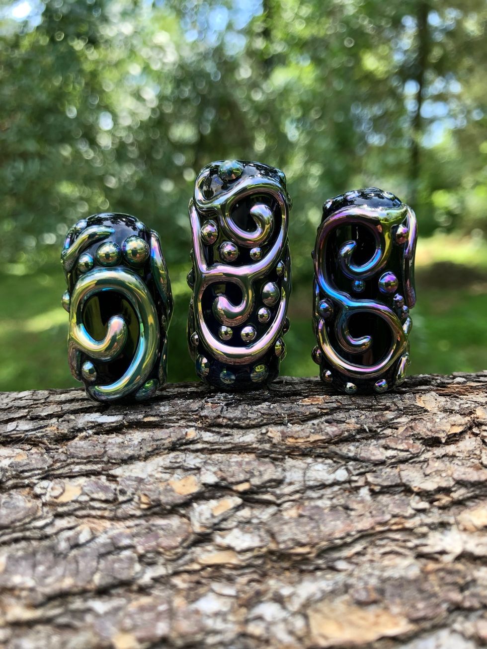 The finished bead will have a raised iridescent metallic luster over a black background.