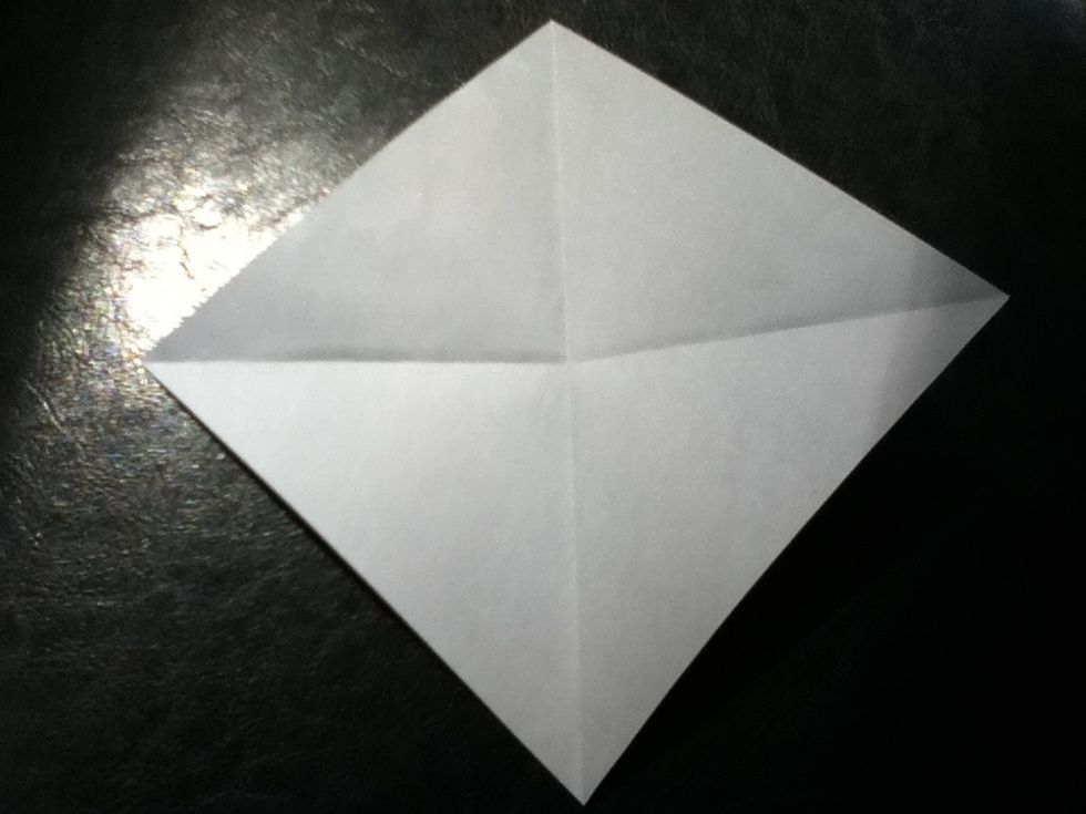 The first 3 steps are making a cushion/blintz base. If you know this, go to step 4. Otherwise, crease your paper corner to corner.
