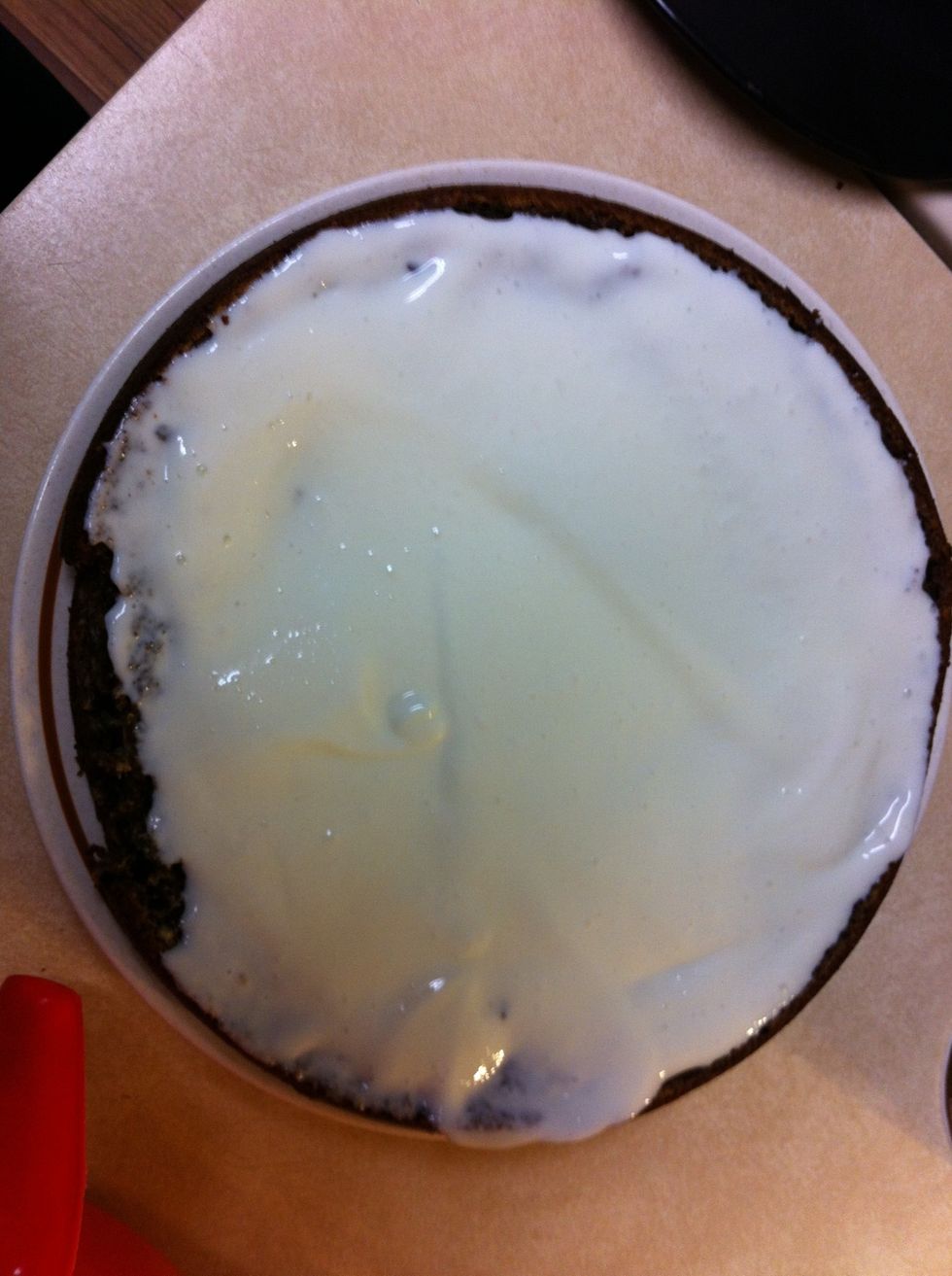 the first part cake is put on a plate and pour cream