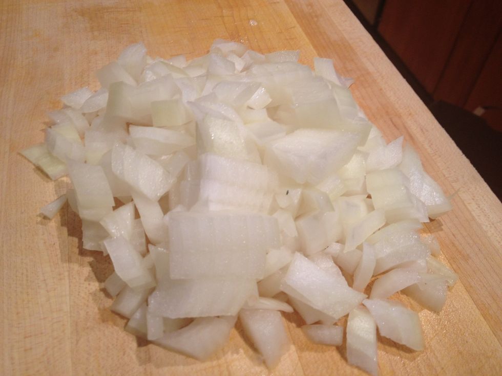 The first step is to dice the onion.