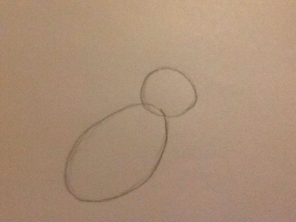 The first step is to draw a small circle (for the head) and a bigger oval (for the body).