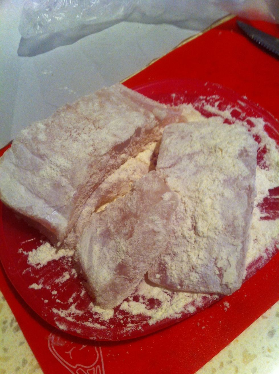 The first step is to toss the fish in the flour. Make sure each piece is evenly coated like so.