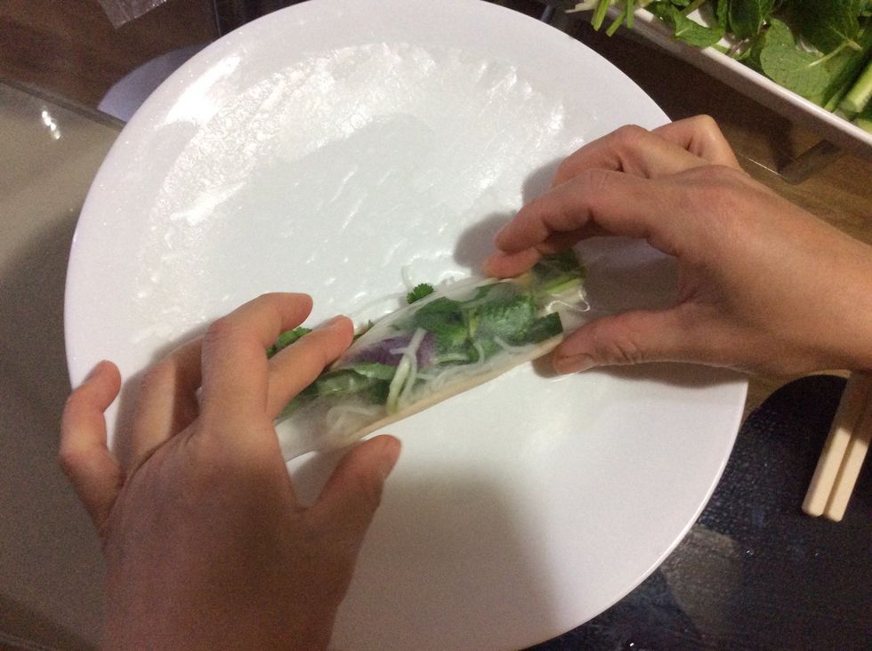 The first step of rolling it is to hold your food in tight, then roll it over once