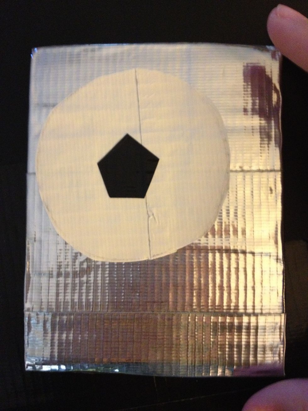 The first thing I draw is a pentagon in the center of the ball, so I cut one out and stuck it onto my painting.