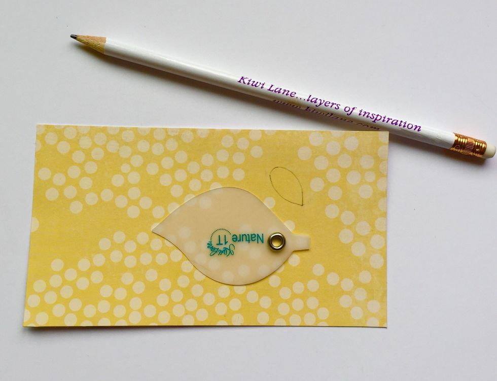 The first thing to do is find a cute paper for your chick and trace the leaf template from the Tiny Nature set. I also drew a little wing to go with it.