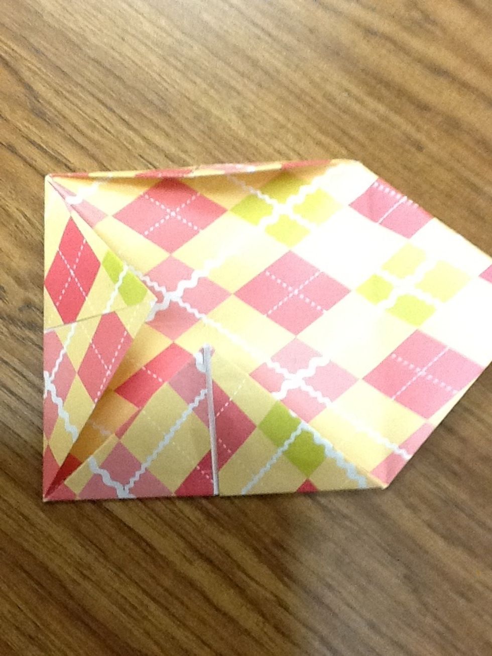 The grab another corner and fold it to the middle.