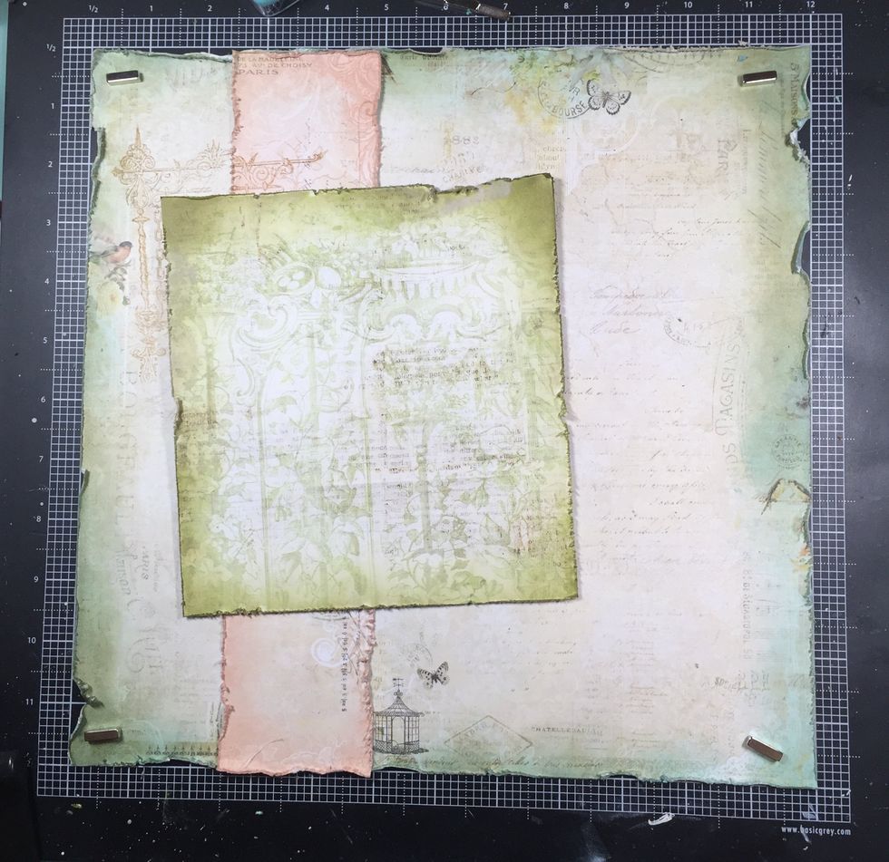 The green layer is glued at an angle, allowing the stamp to frame the corner.